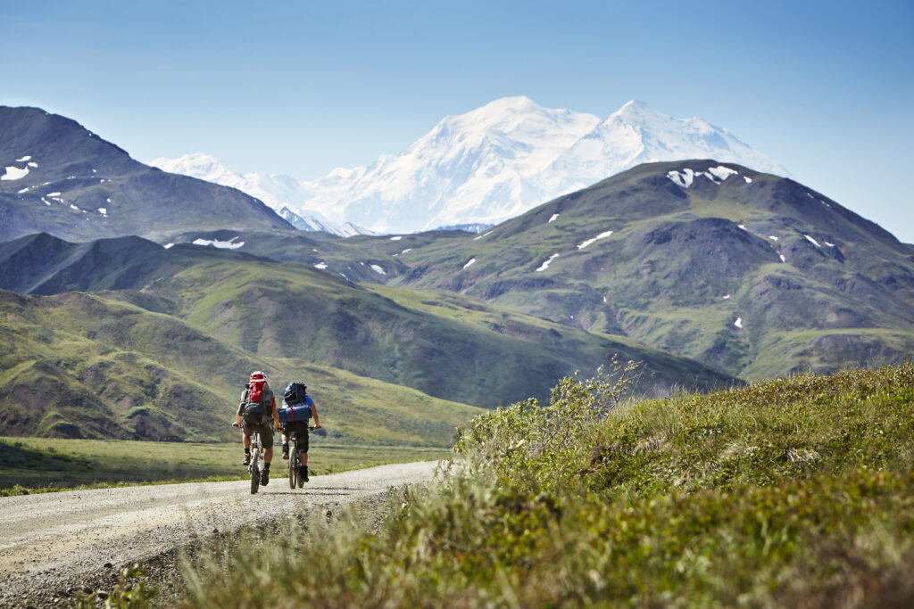Cycling on rural road, Mount McKinley, Denali National Park, Alaska, USA